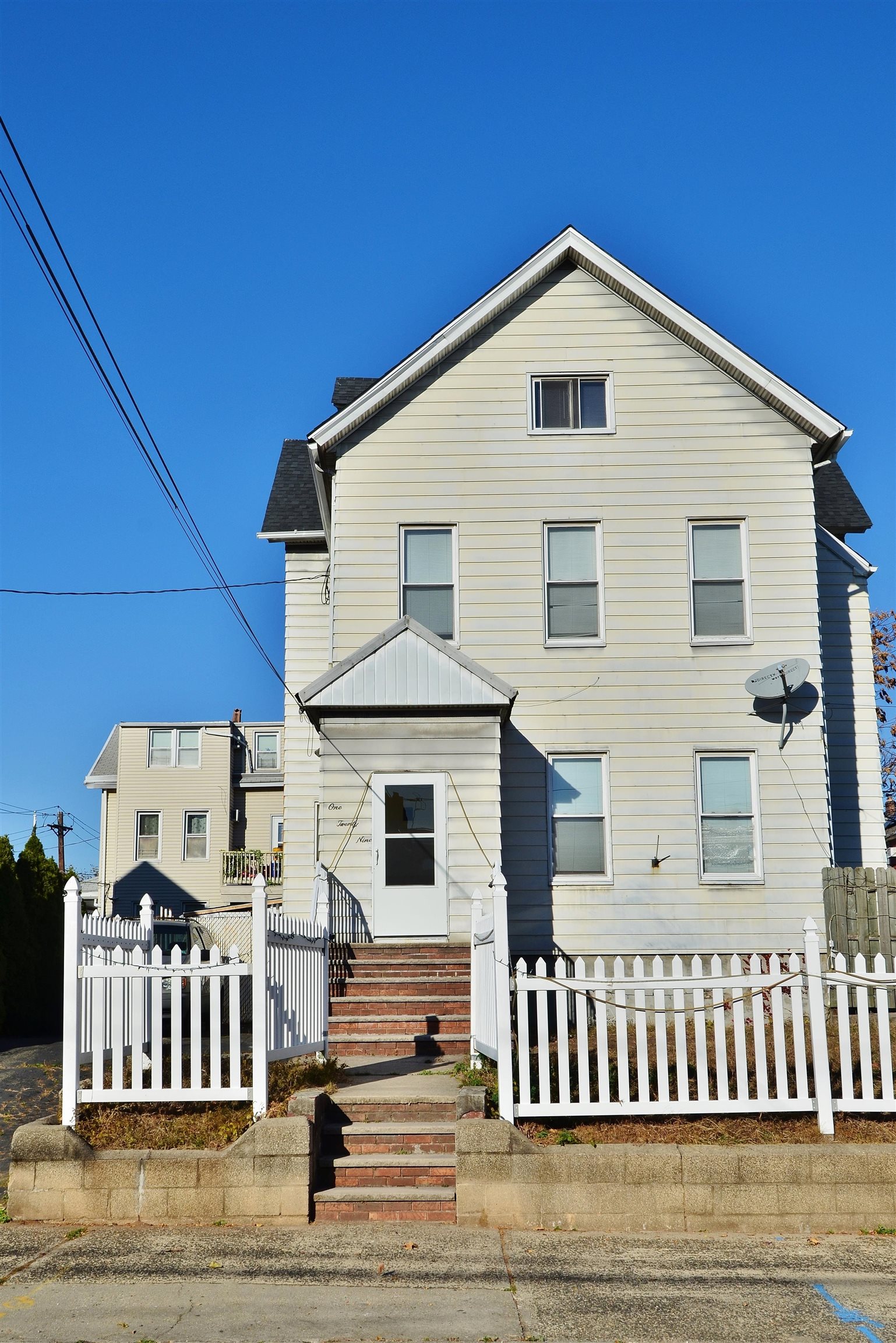 a front view of a house with a fence