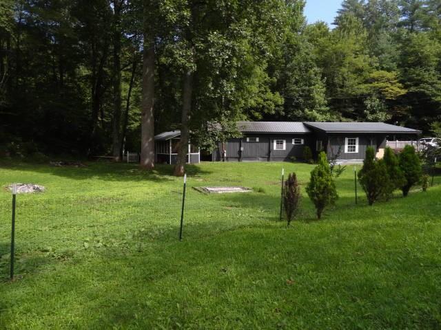 a view of a house with a backyard