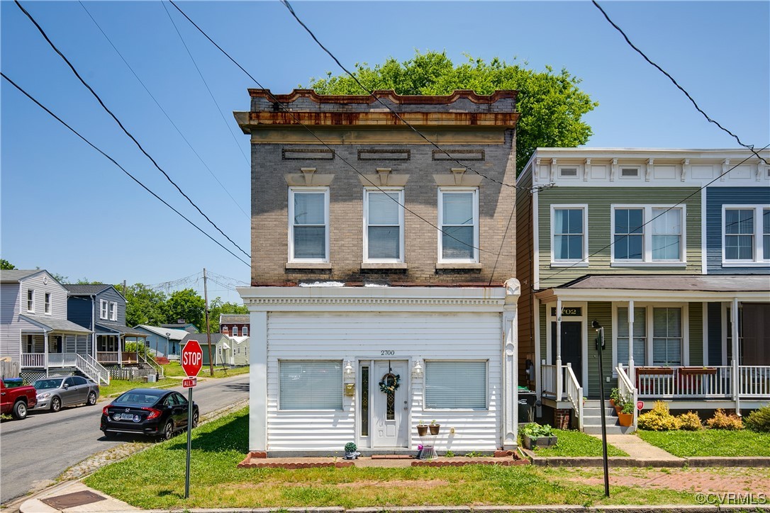 a front view of multiple houses with yard