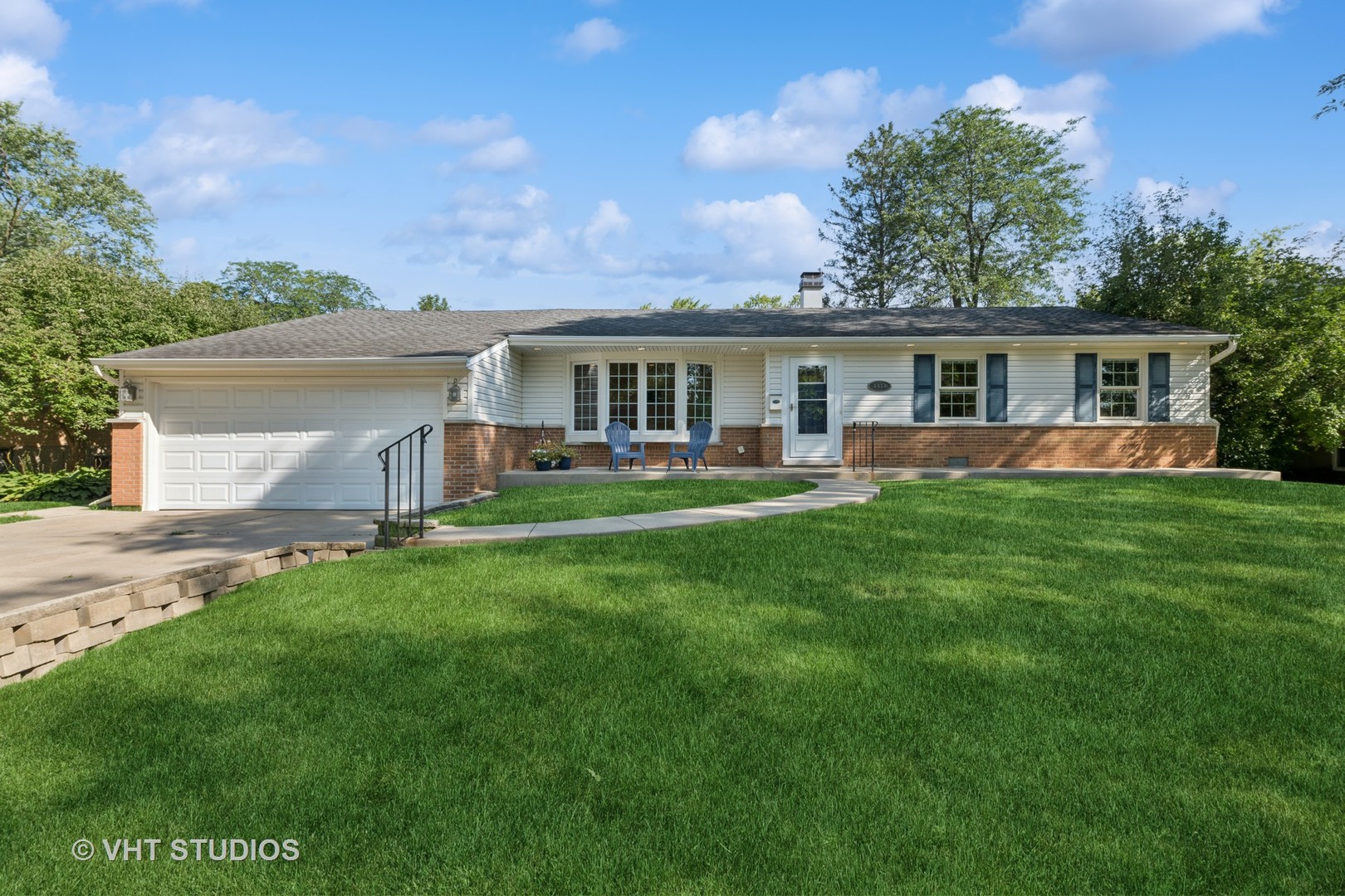 a front view of house with yard and green space