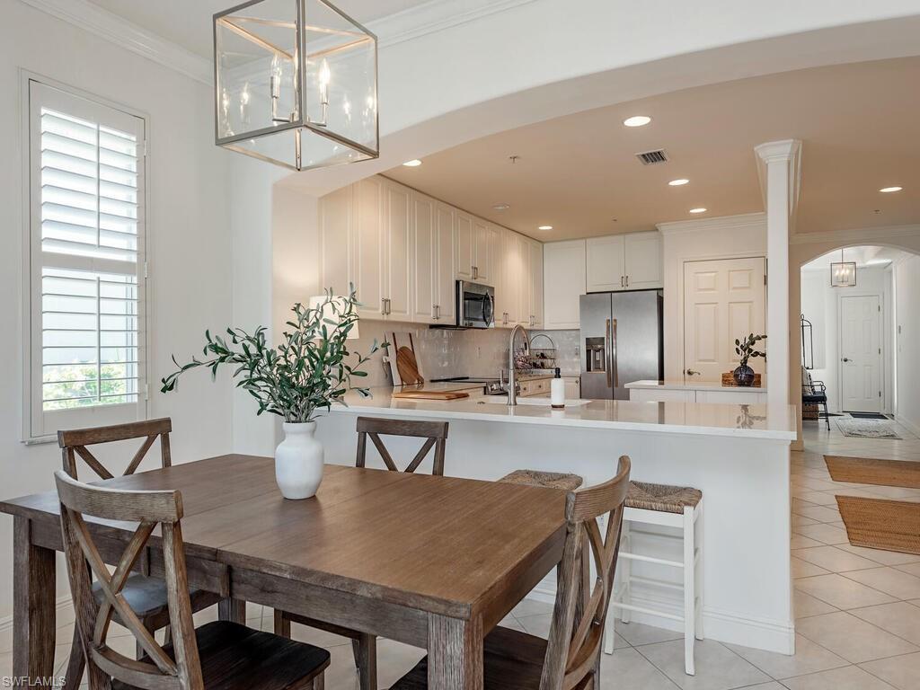 a view of a dining room with furniture a chandelier and wooden floor