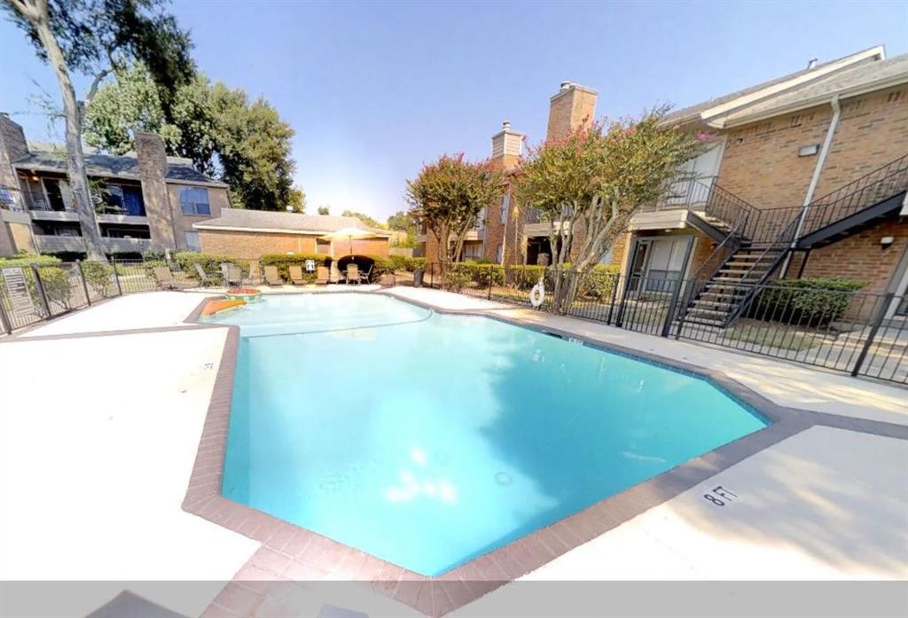 a view of a swimming pool with a patio