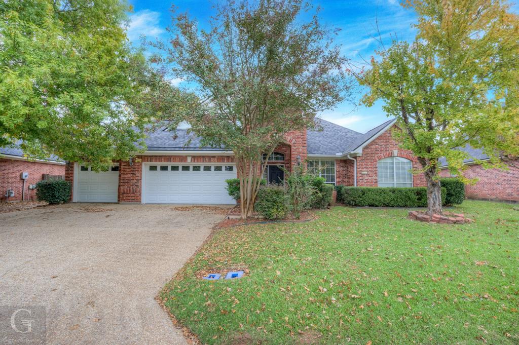 a view of a house with a yard and garage