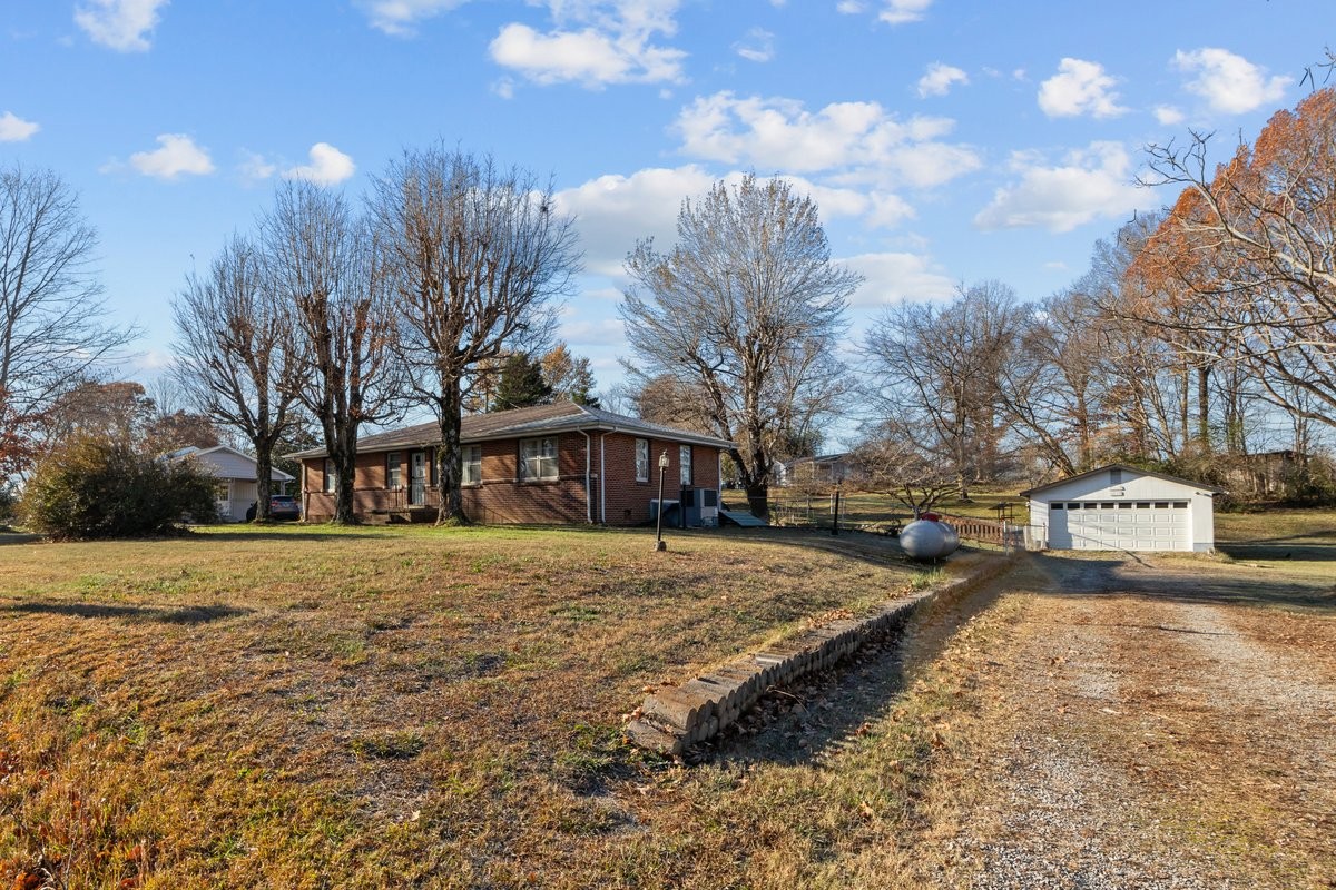 a view of a yard with a house in the background