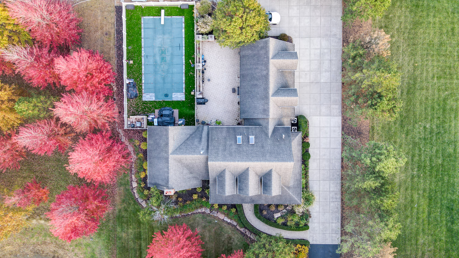 aerial view of a house with a yard and garden