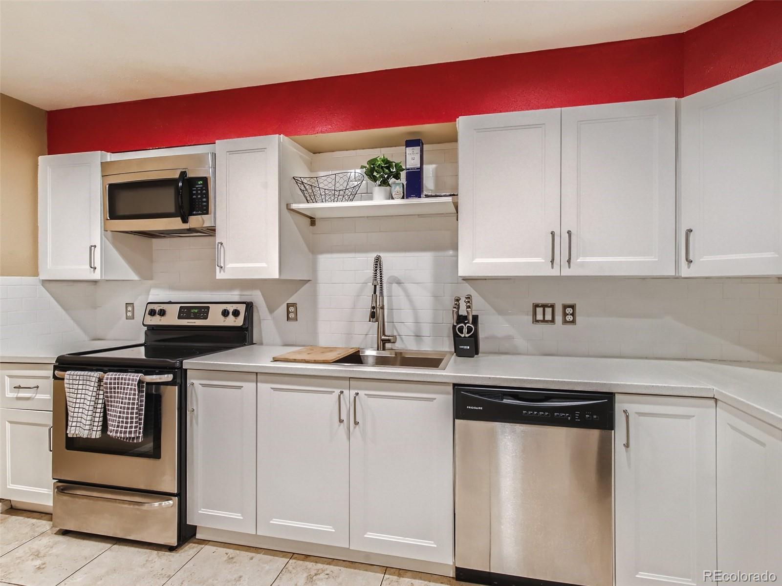 a kitchen with stainless steel appliances granite countertop a stove and a microwave