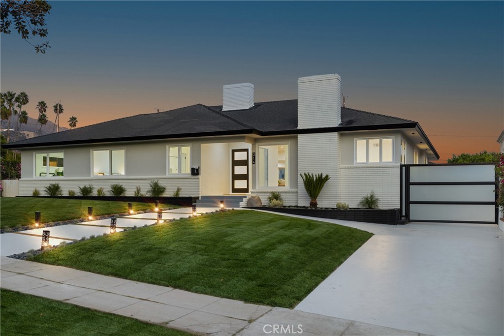 a front view of house with yard and green space