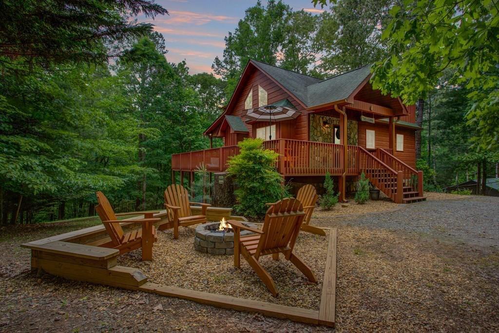 a view of a house with a yard and furniture