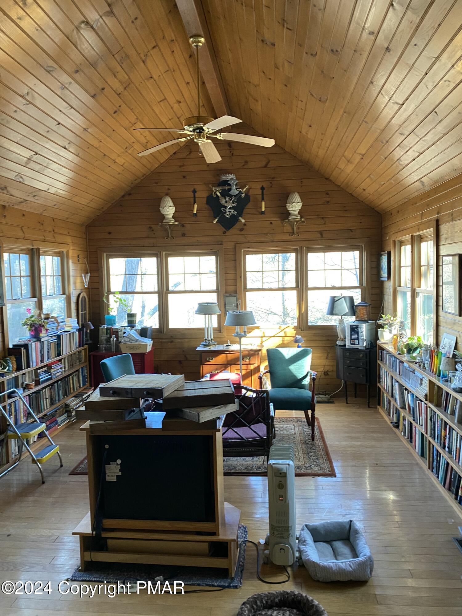 a living room with lots of furniture and a potted plant