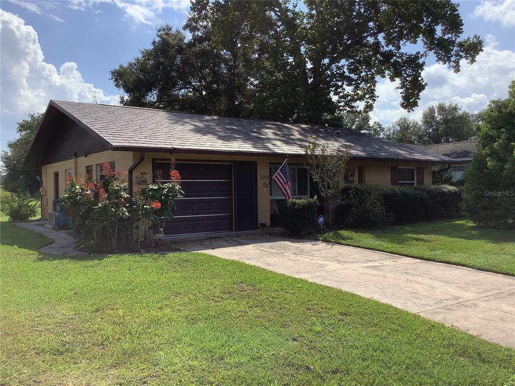 a front view of a house with a yard and a garage