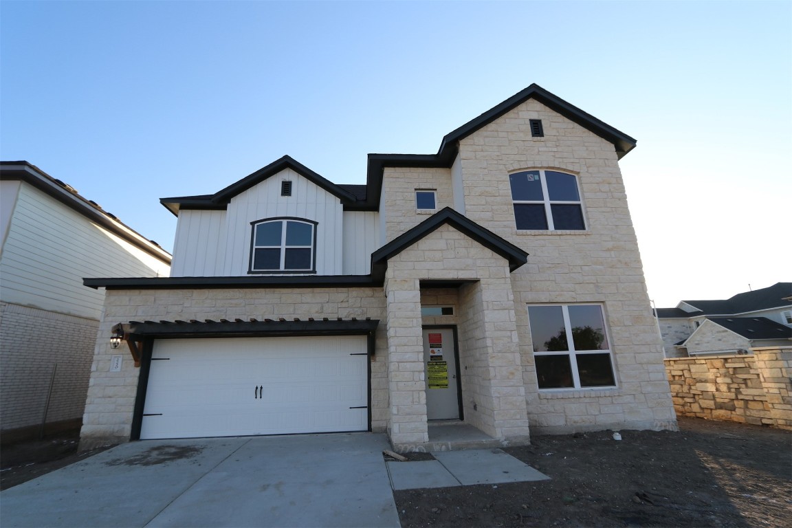 a front view of a house with a garage