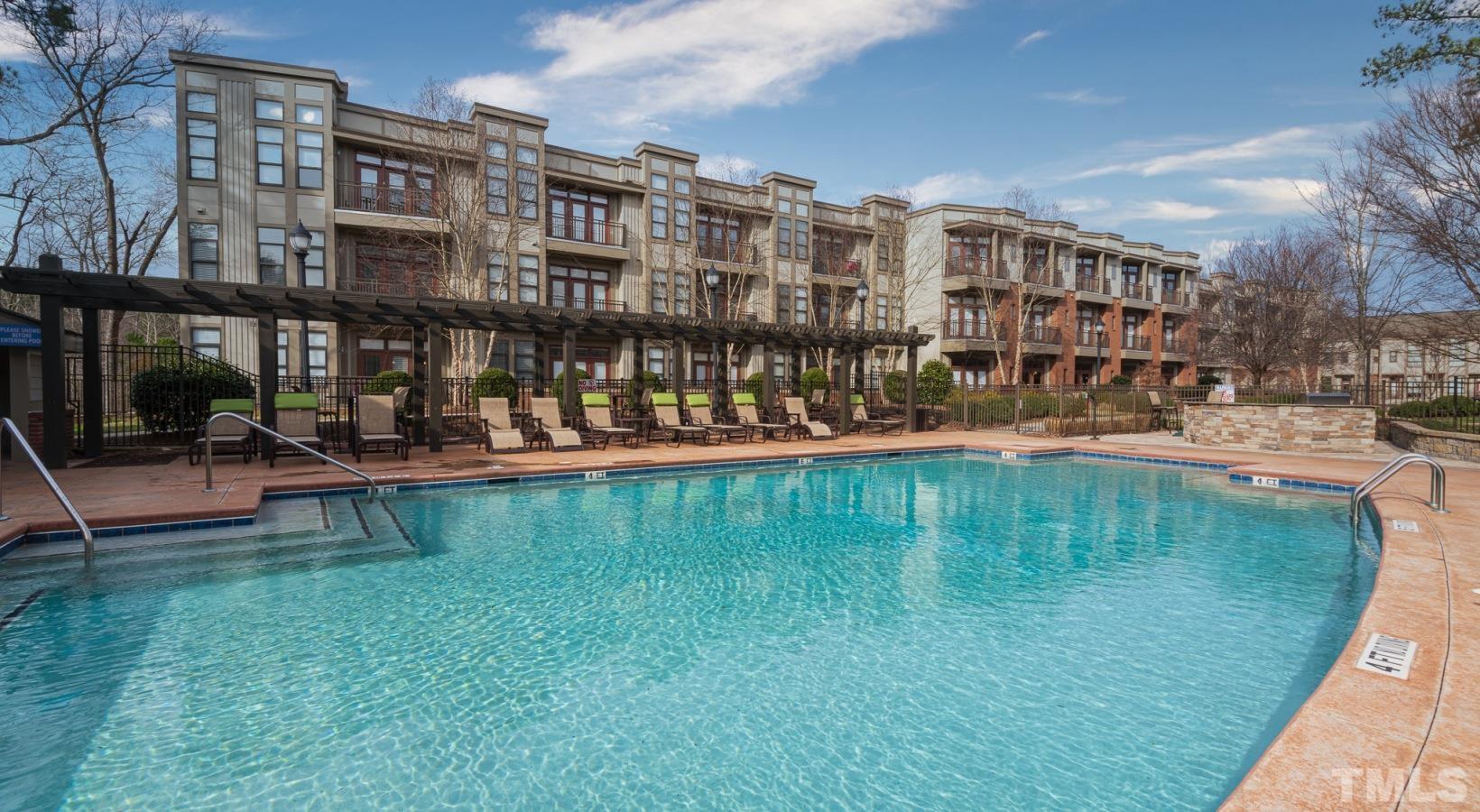 a swimming pool view with a outdoor seating