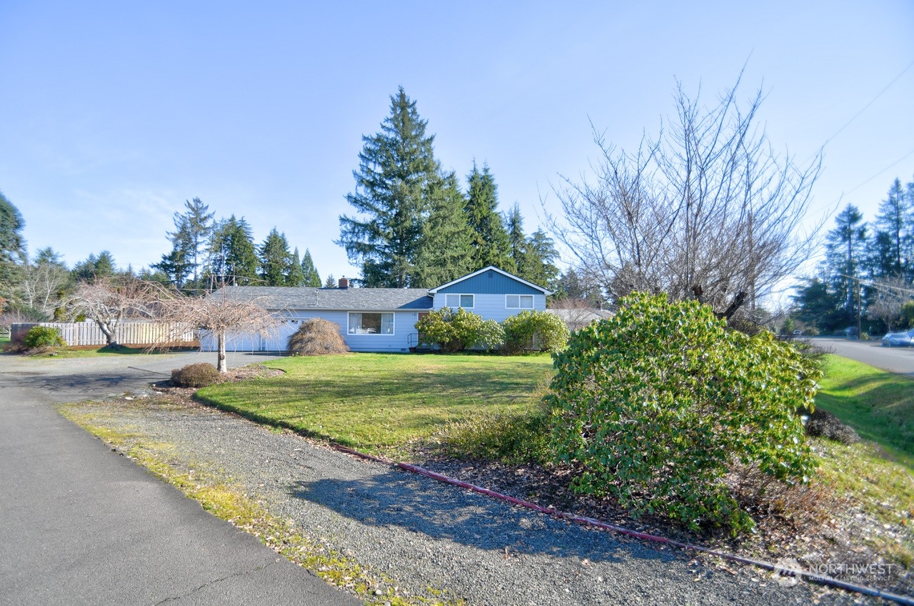 a front view of house with yard and trees