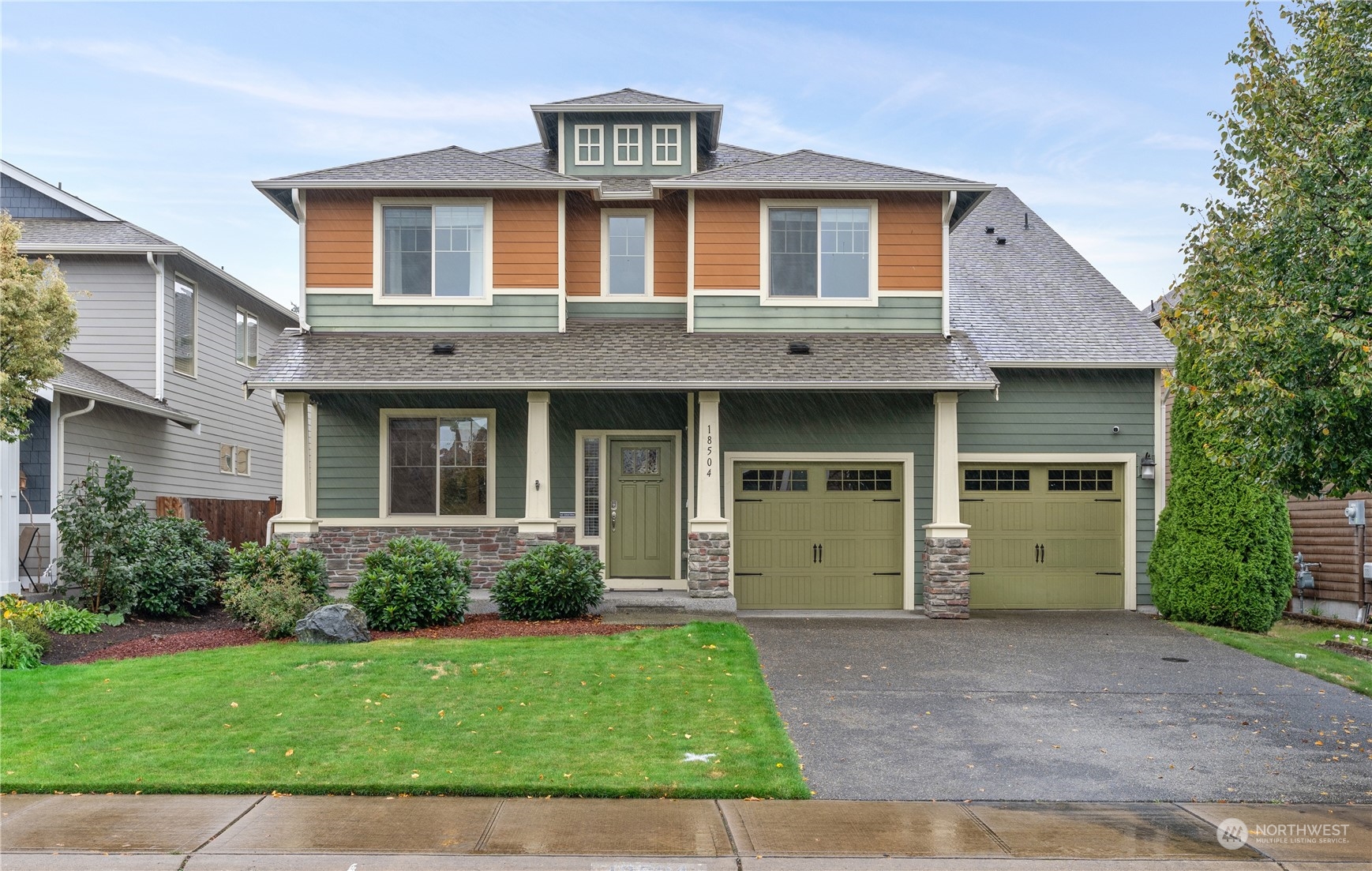 a front view of a house with a garden