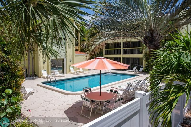 an outdoor space with furniture and umbrella