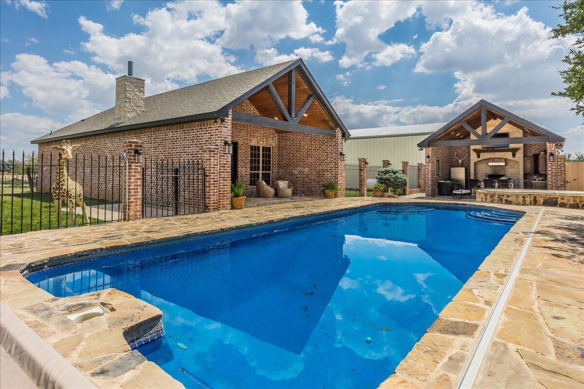 a front view of house with yard outdoor seating and barbeque oven