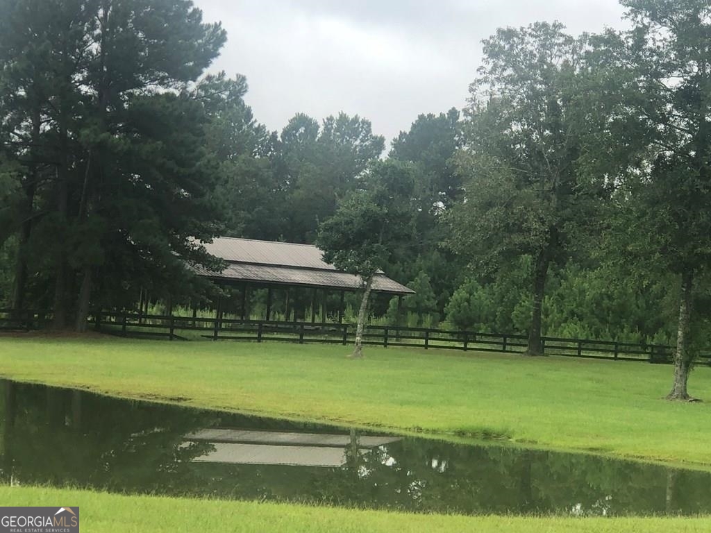 a view of a swimming pool with a yard