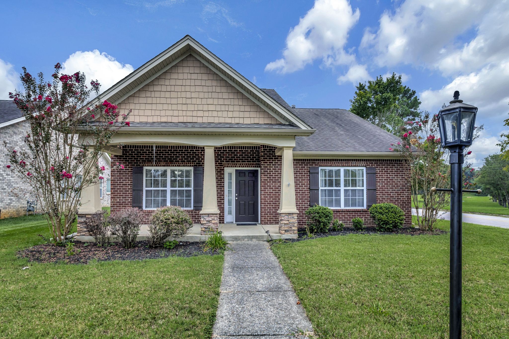 a front view of a house with garden