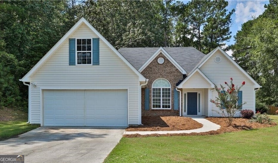 a front view of a house with a yard and garage