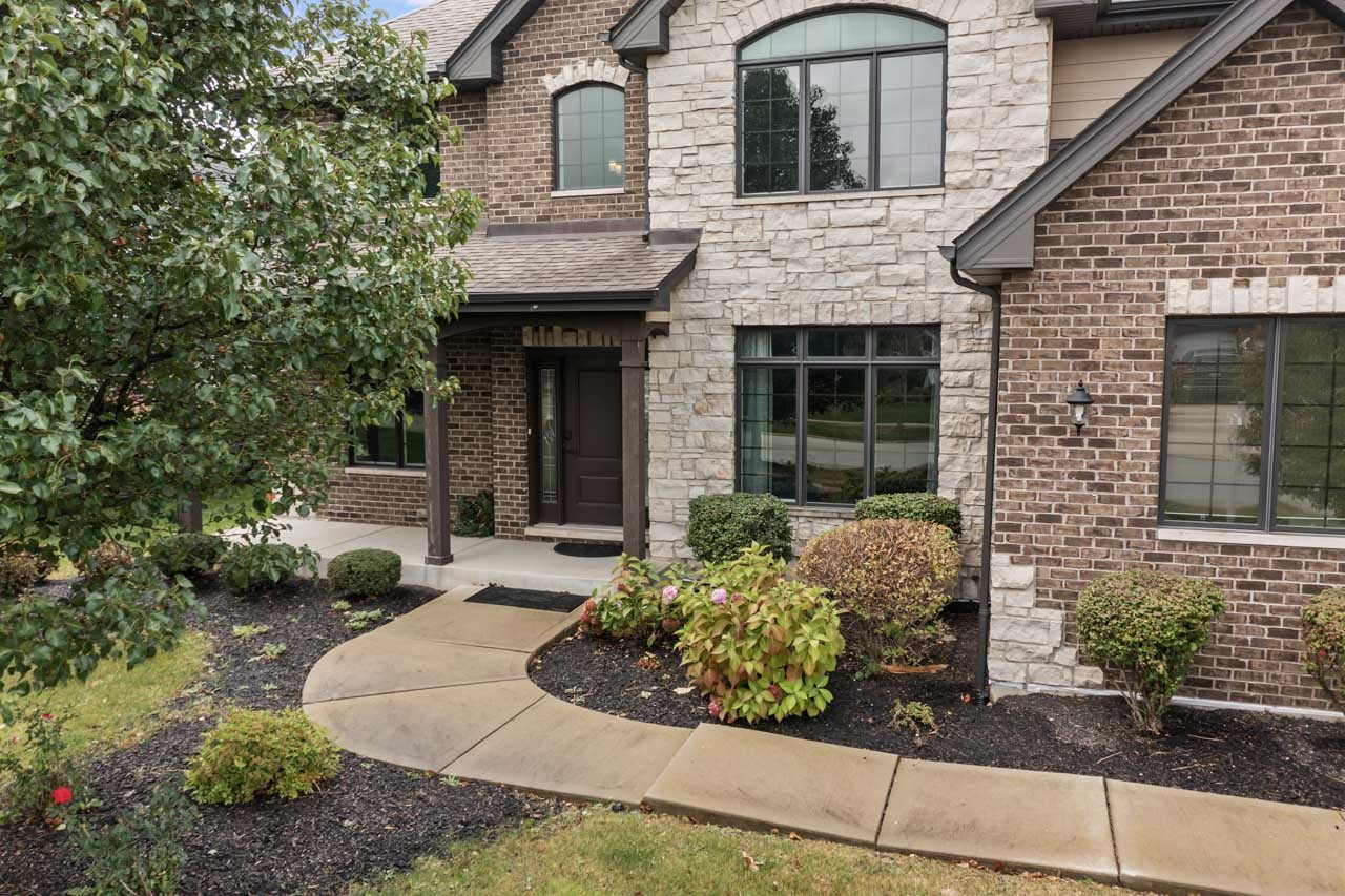 a front view of a house with garden