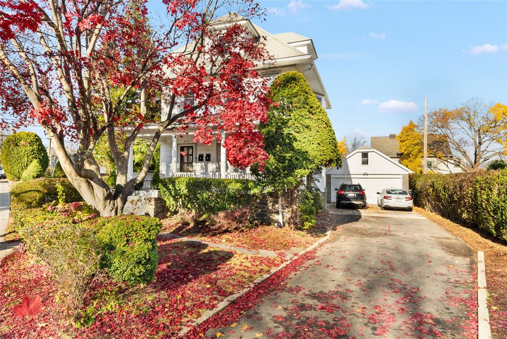 a view of a house with a yard and pathway