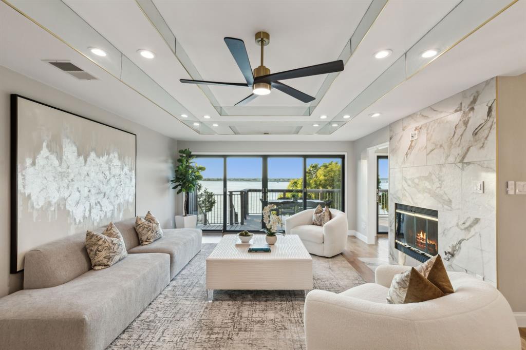 a living room with furniture fireplace and a large window