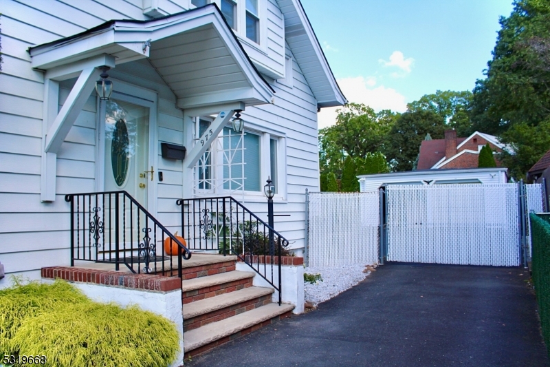 a view of backyard with deck and wooden fence