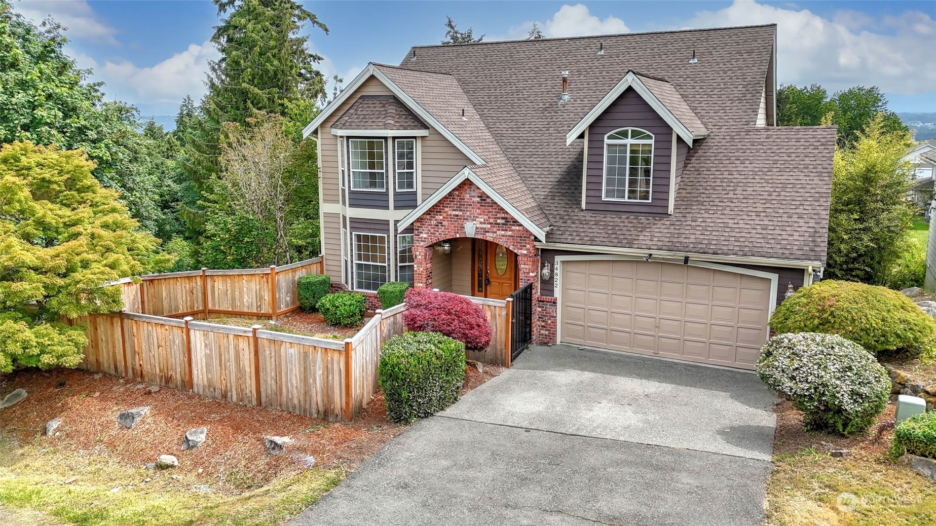 a front view of a house with a yard and garage