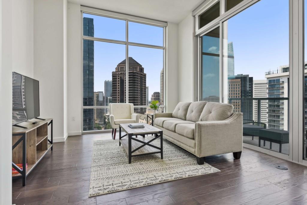 a living room with furniture a rug and a window