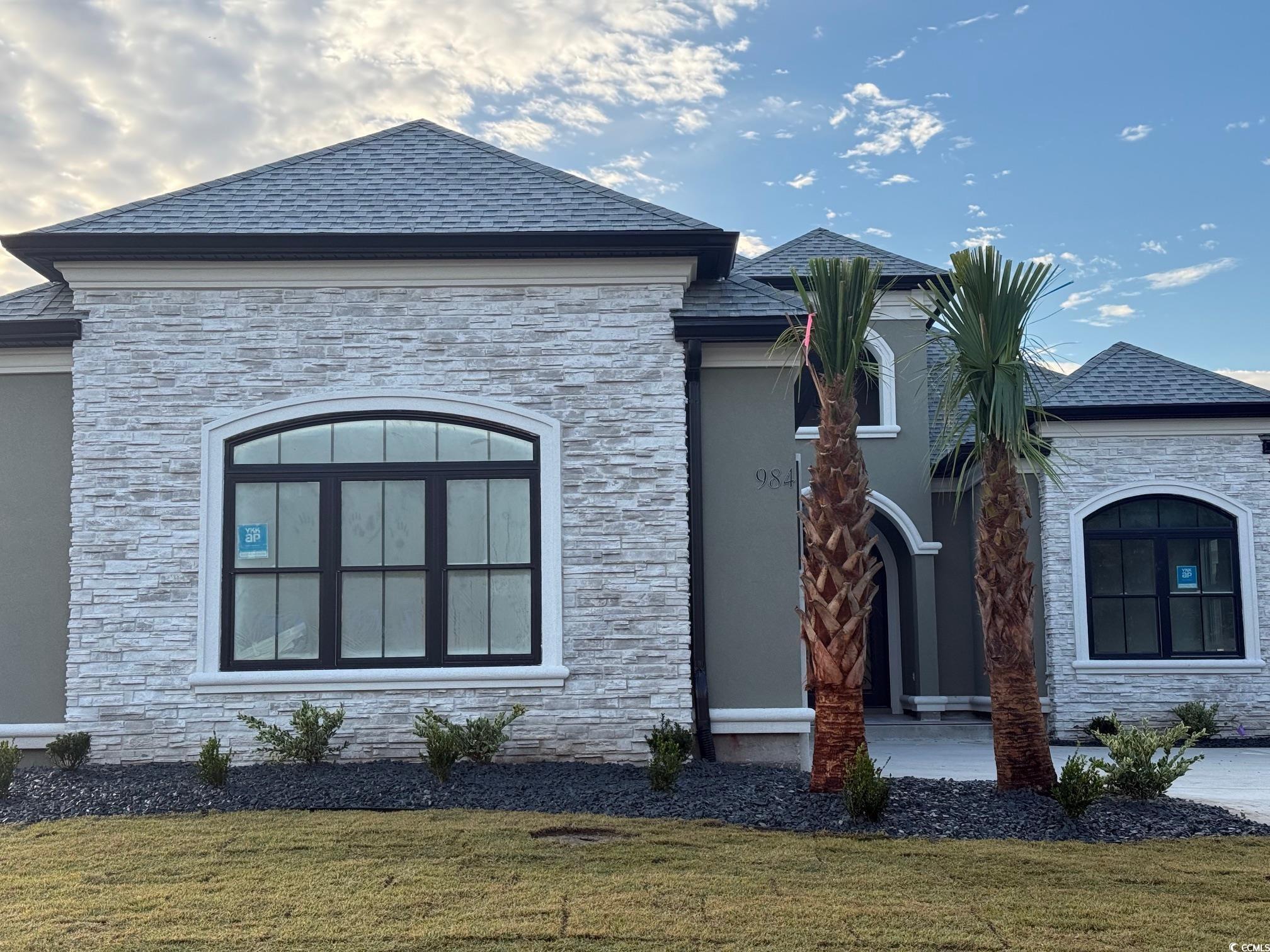 View of property exterior featuring a lawn