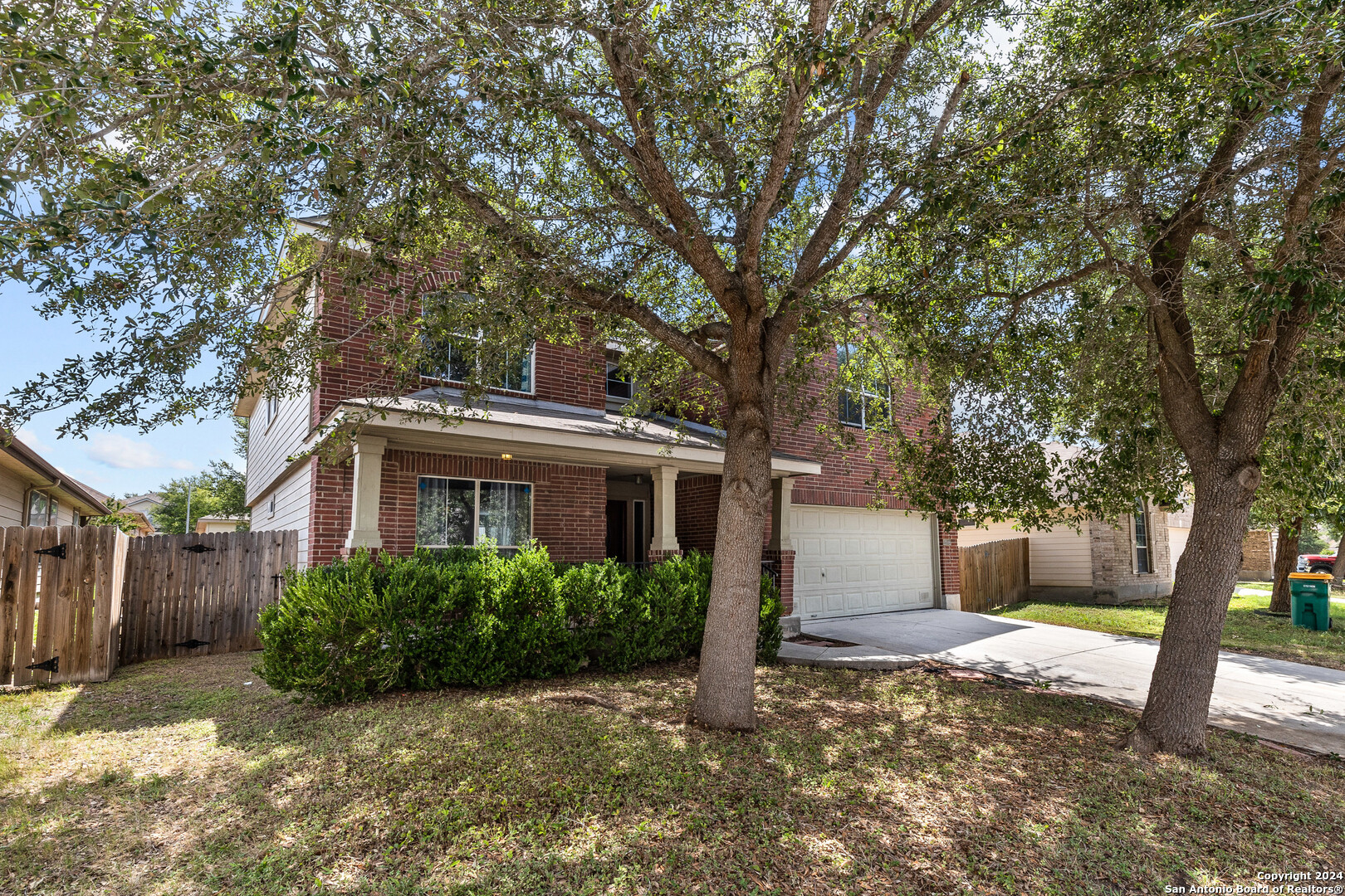 a house that has a tree in front of the house