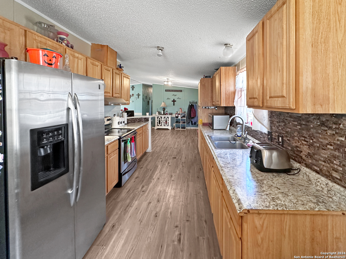 a kitchen with lots of counter top space and stainless steel appliances