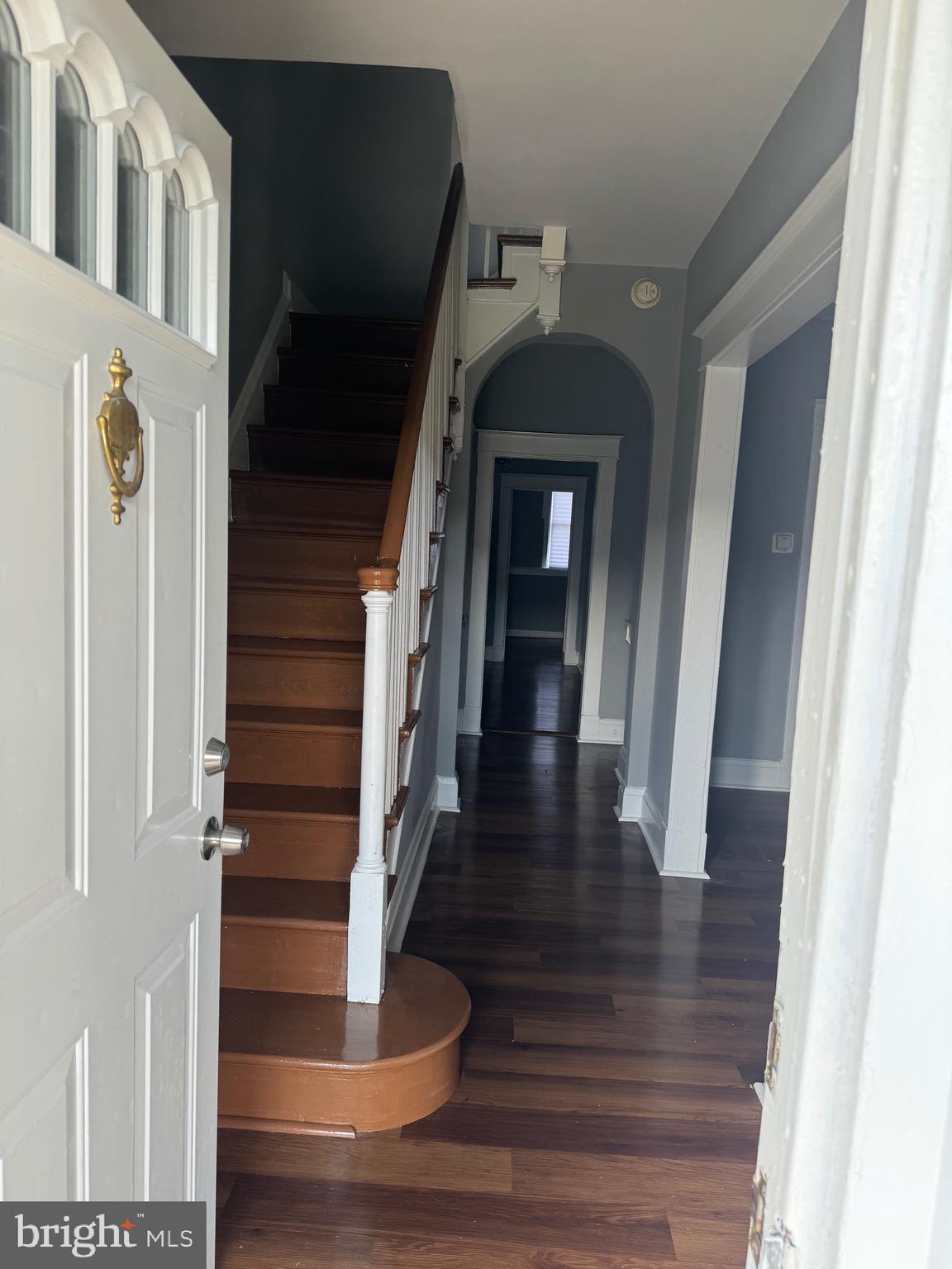 a view of entryway and hall with wooden floor