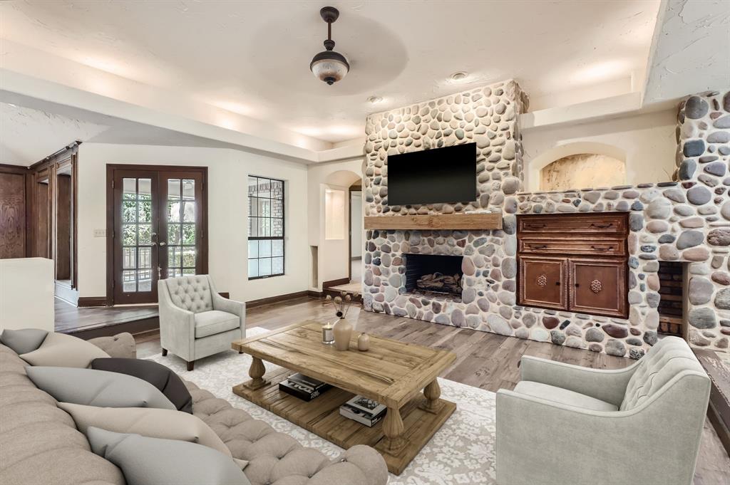 a living room with furniture a flat screen tv and a fireplace