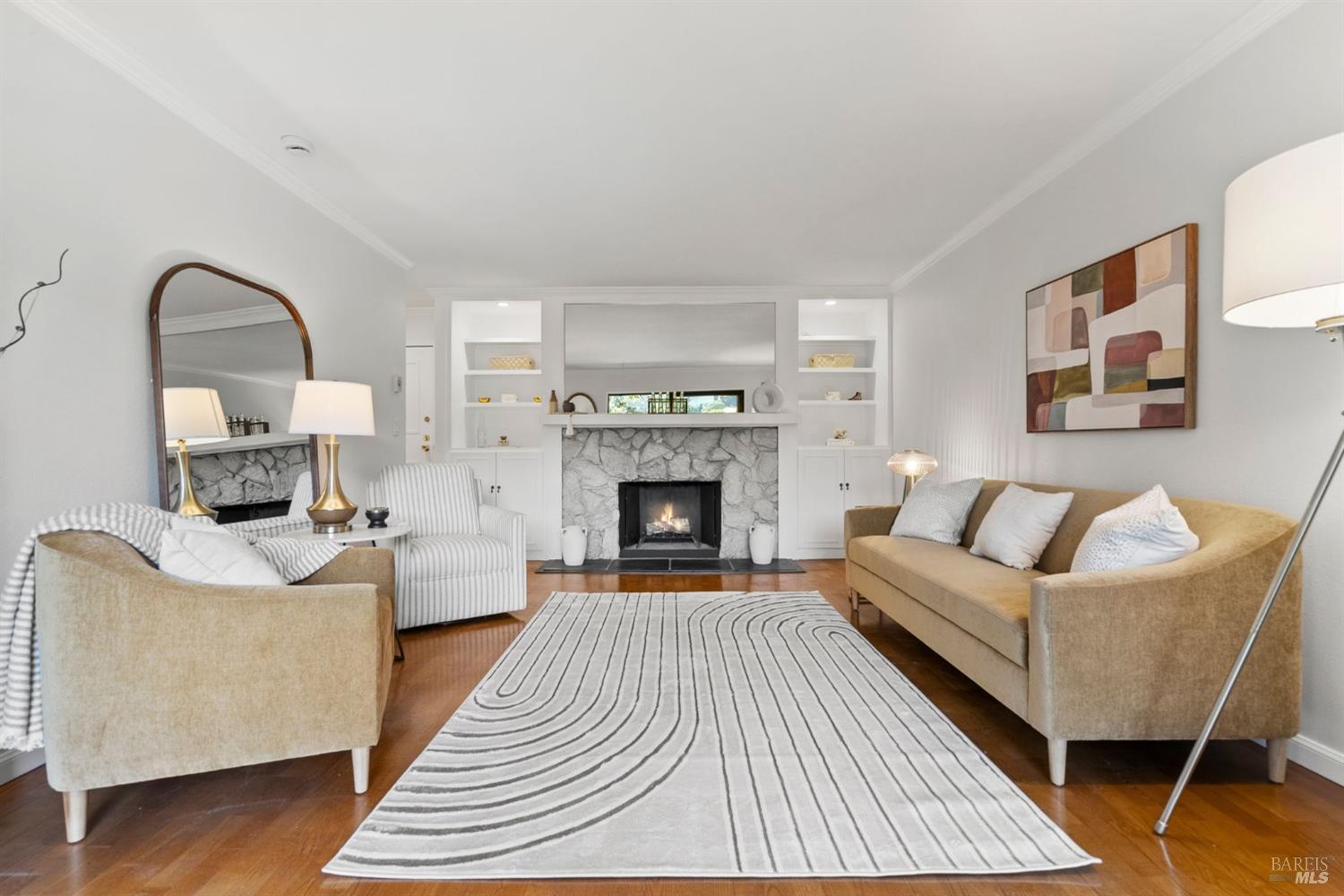 a living room with furniture a fireplace and a wooden floor