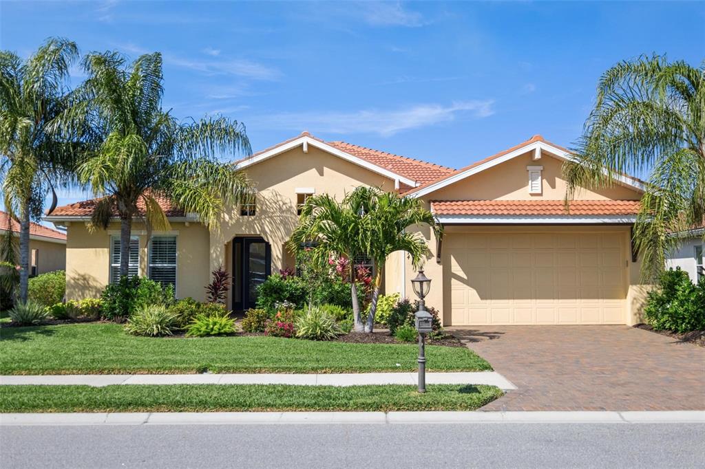 a front view of a house with a yard and garage