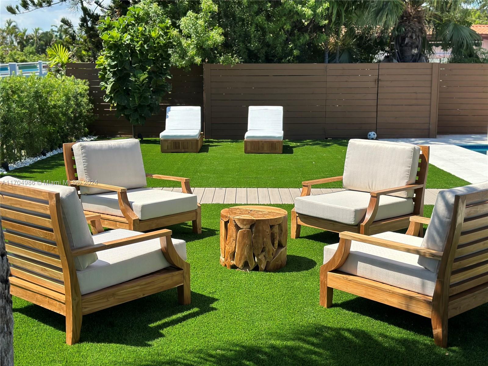 a view of a patio with chairs and a table