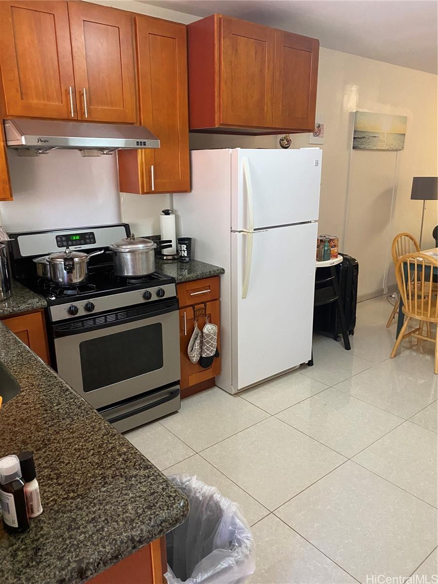 a kitchen with cabinets and a stove top oven