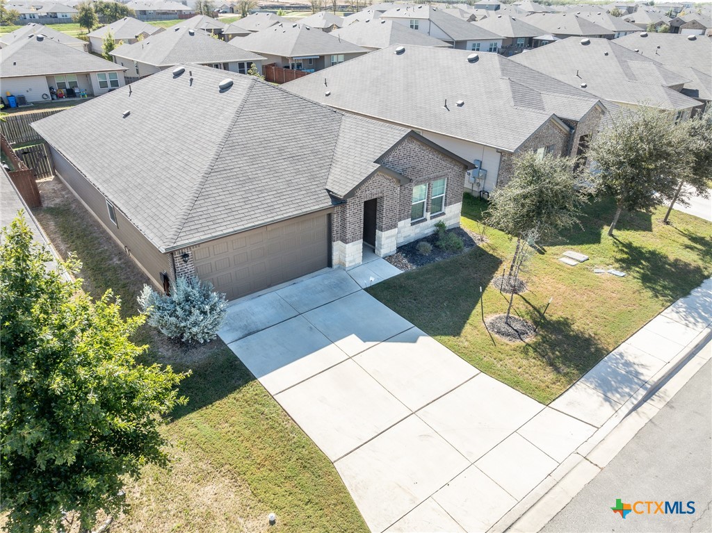 an aerial view of a house with a yard