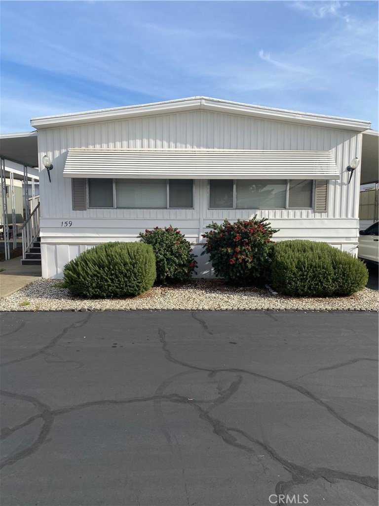 a front view of a building with a garden