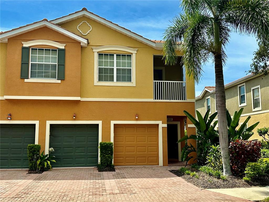 a front view of a house with a yard and garage