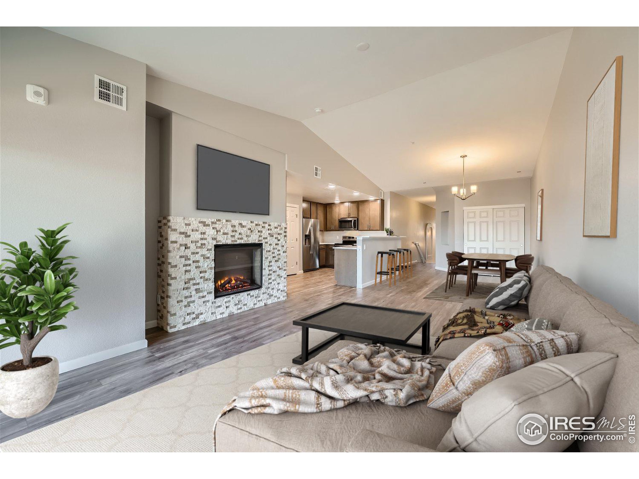 a living room with furniture a fireplace and a potted plant