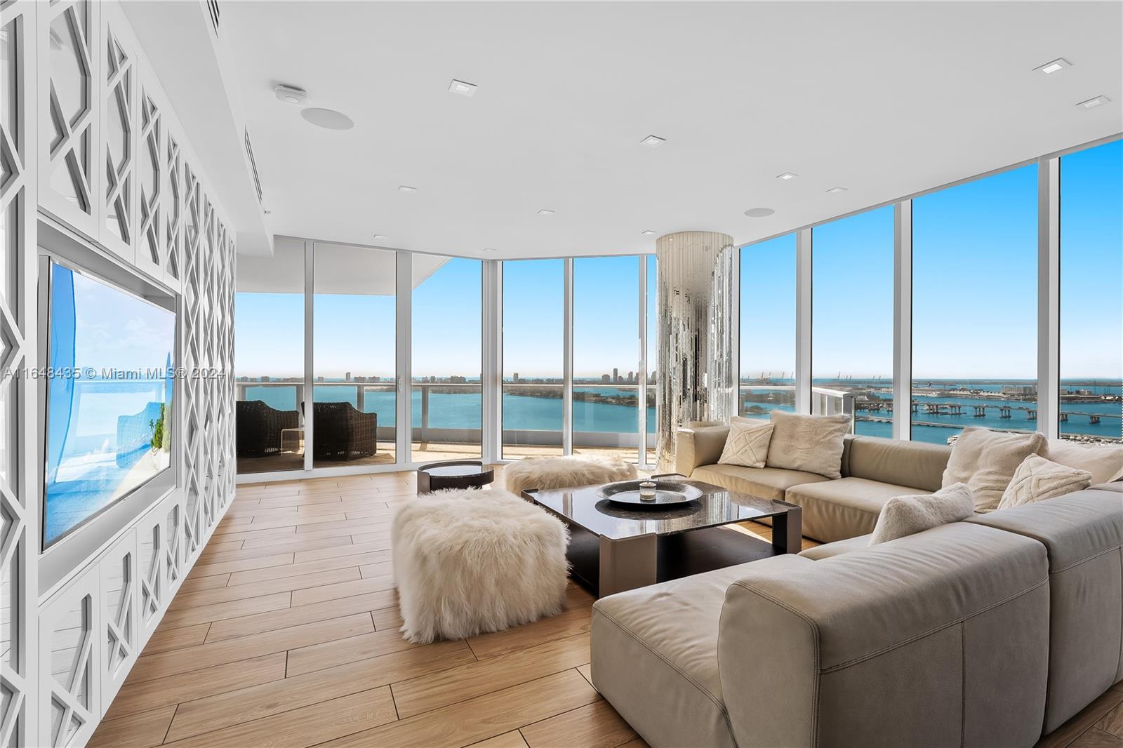 a living room with furniture and large windows