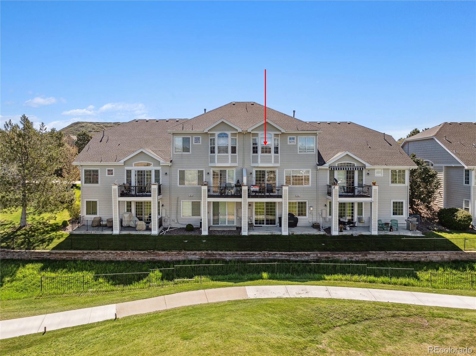 a front view of a house with a yard swimming pool and outdoor seating