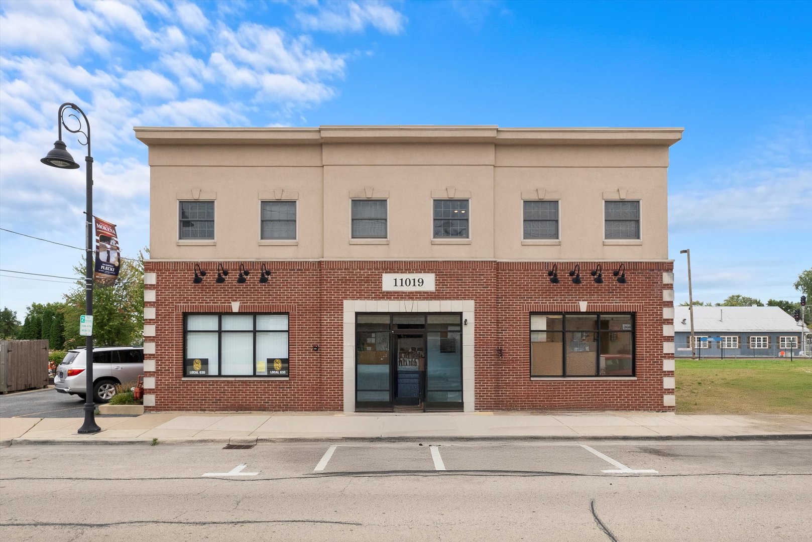 a view of building with car parked