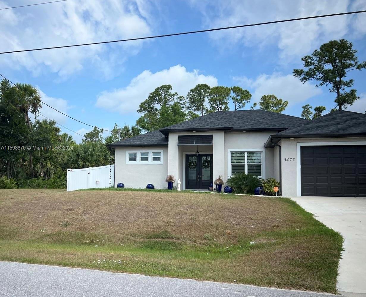 a front view of a house with a garden and plants