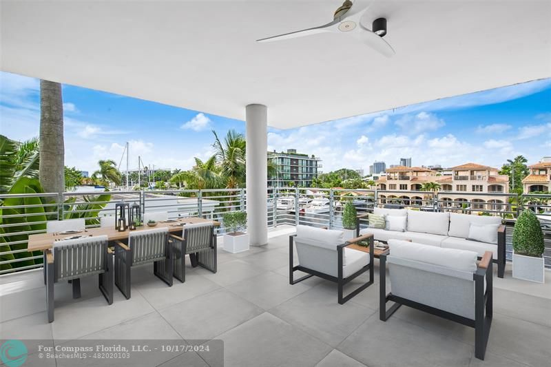 a balcony with furniture and a floor to ceiling window