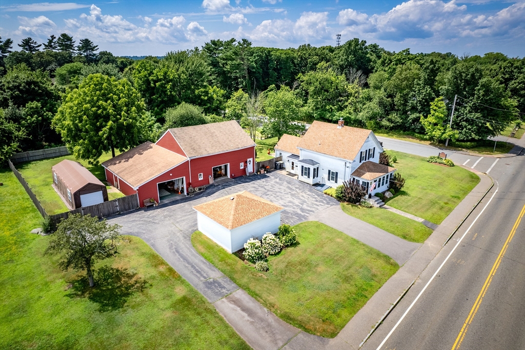 an aerial view of a house with a garden and swimming pool