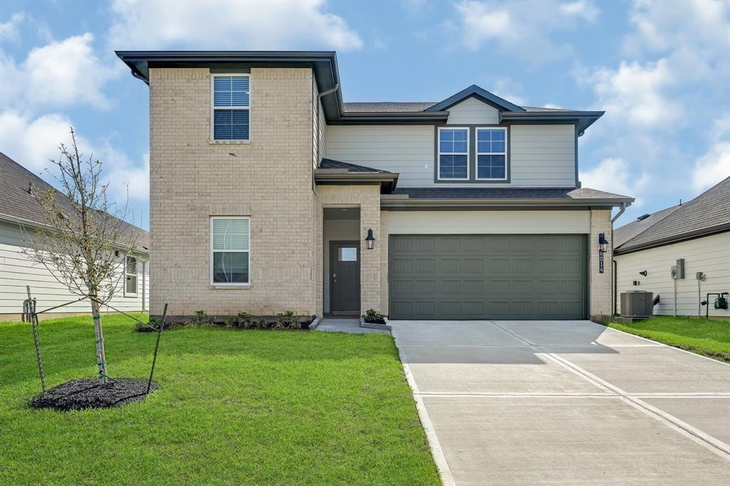 a front view of a house with a yard and garage