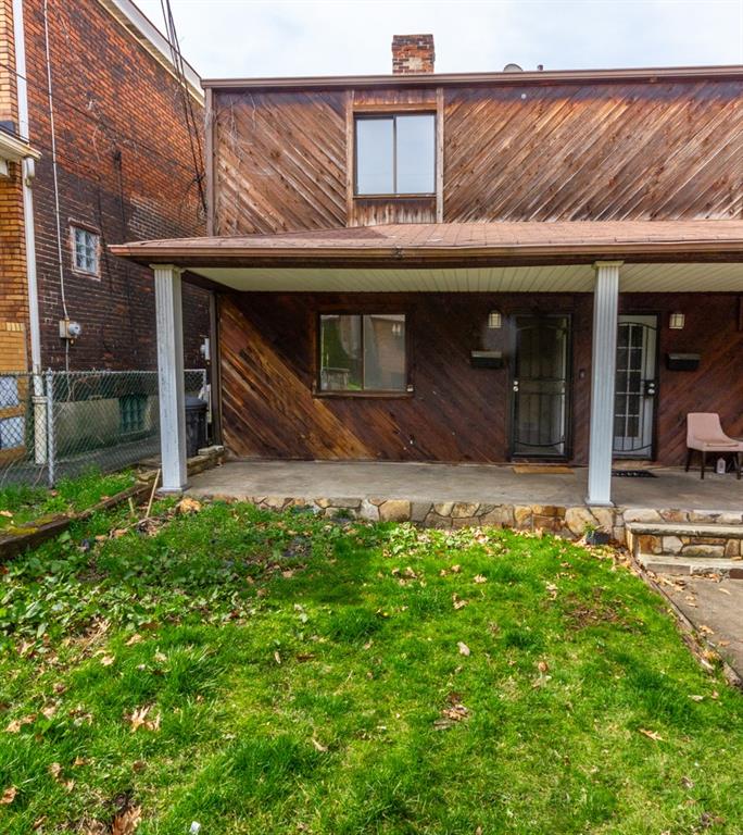 a view of a house with a small yard